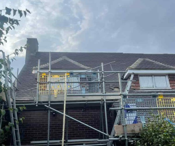 This is a photo of a roof with two dormers that is having some damaged tiles replaced. Works carried out by STW Roofing Flitwick