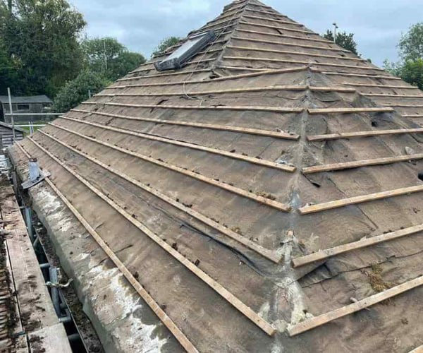 This is a photo of a hip roof that has been stripped back to the battens, and is awaiting a new roof covering to be installed. Works carried out by STW Roofing Flitwick